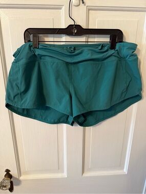 Lululemon Speed Up shorts in a teal blue-green color. Size 14.